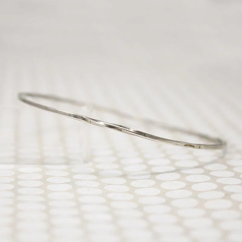 luxury bangles for women -The Endless Twist Round Bangle in Sterling from Allie B.